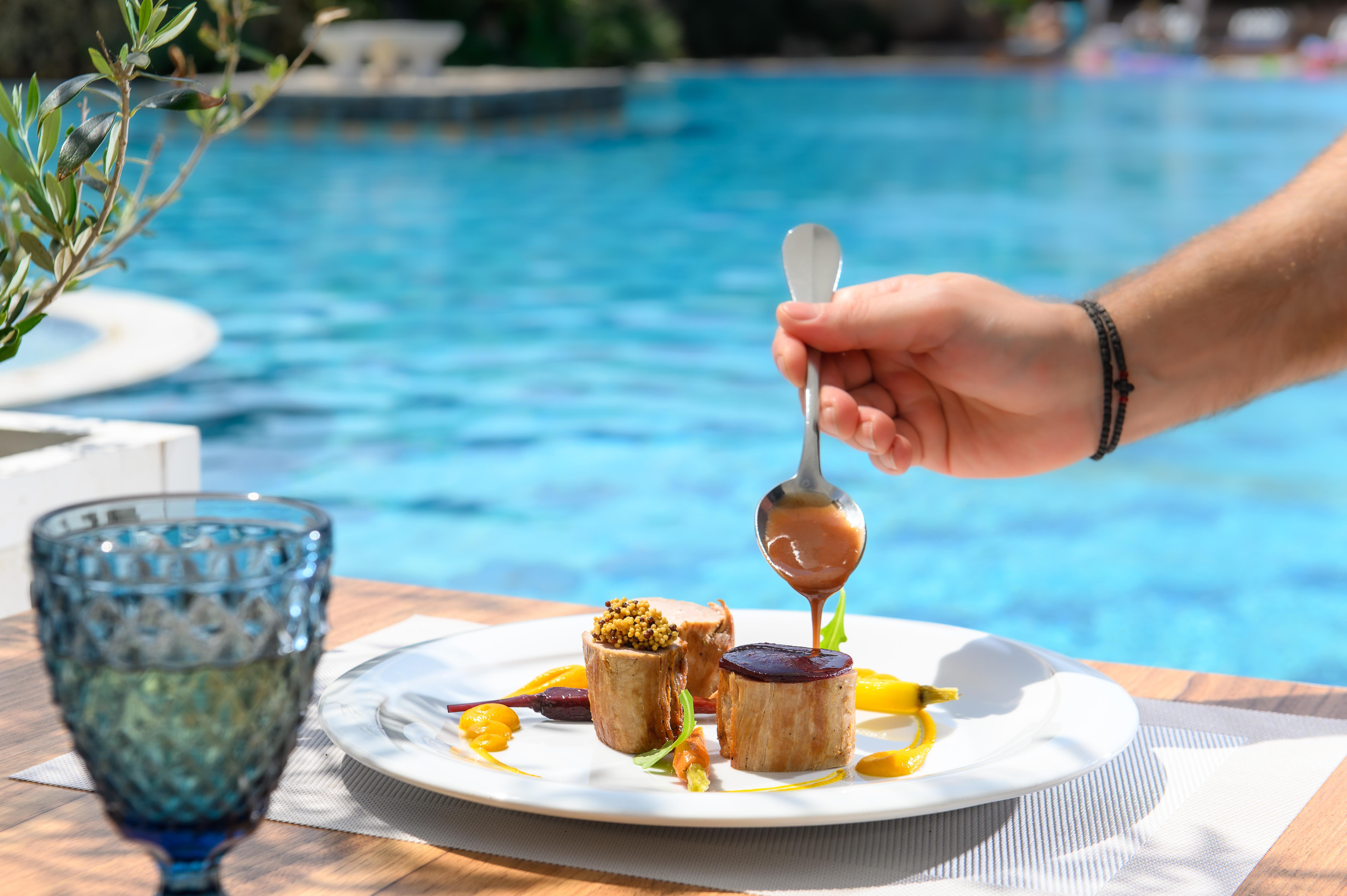 Minos Imperial Luxury Beach Resort & Spa Milatos Exterior photo A hand holding a spoon